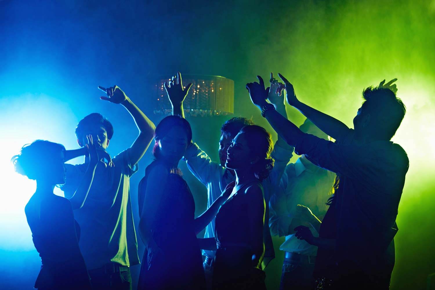 depicts a group of people dancing in a club or party setting