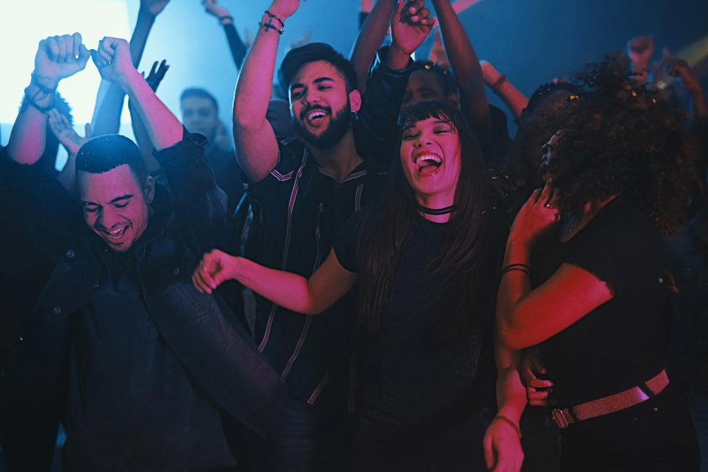 group of friends dancing in a club