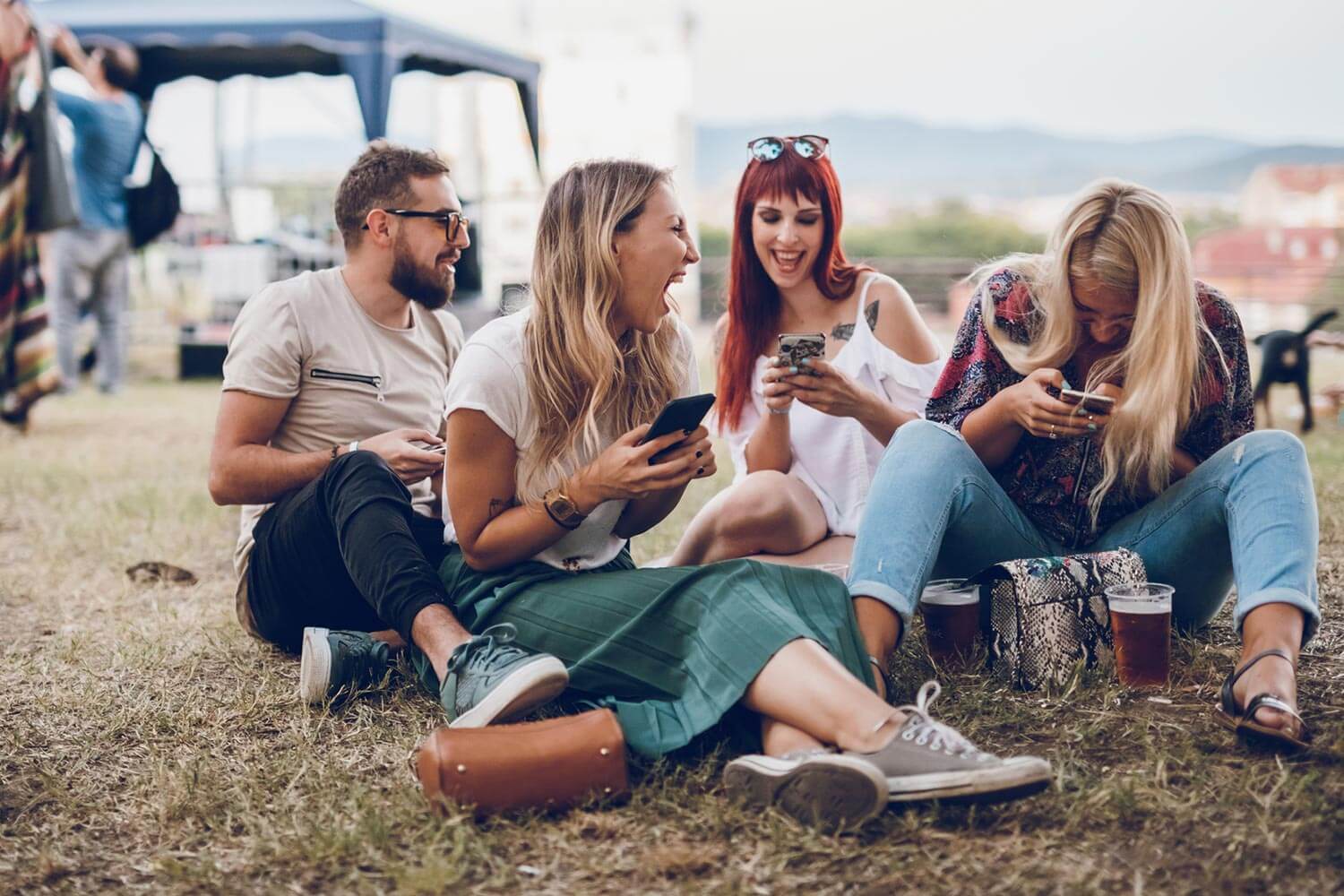 group of friends sat on grass