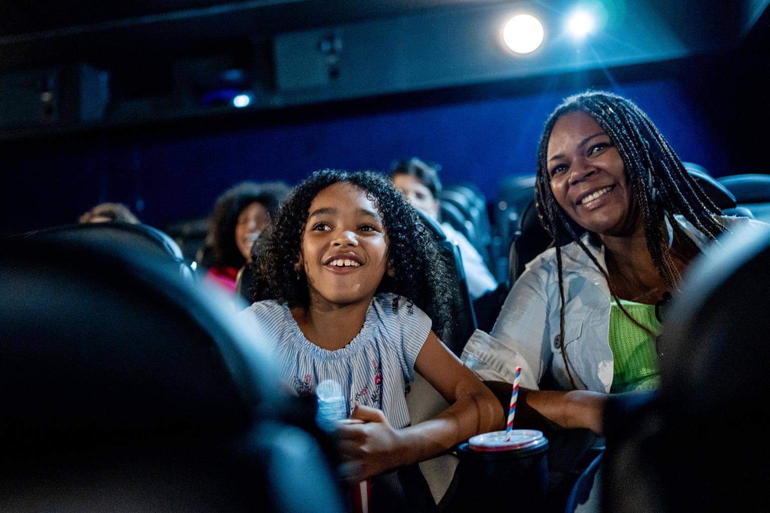 mother and daughter watching a theatre production