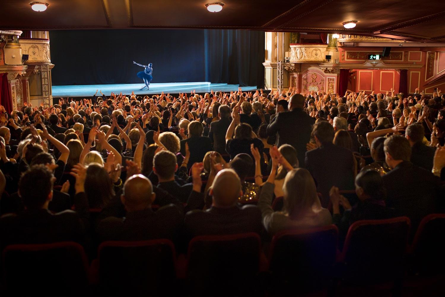 theatre goeers applauding performance of dancer