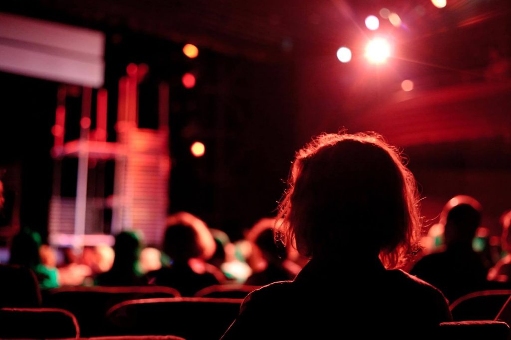 woman in theatre audience waiting for the show to start