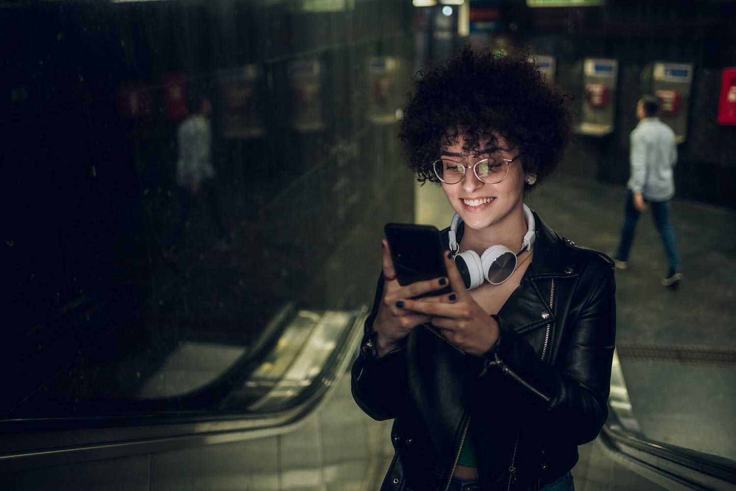 woman on her phone on an escalator