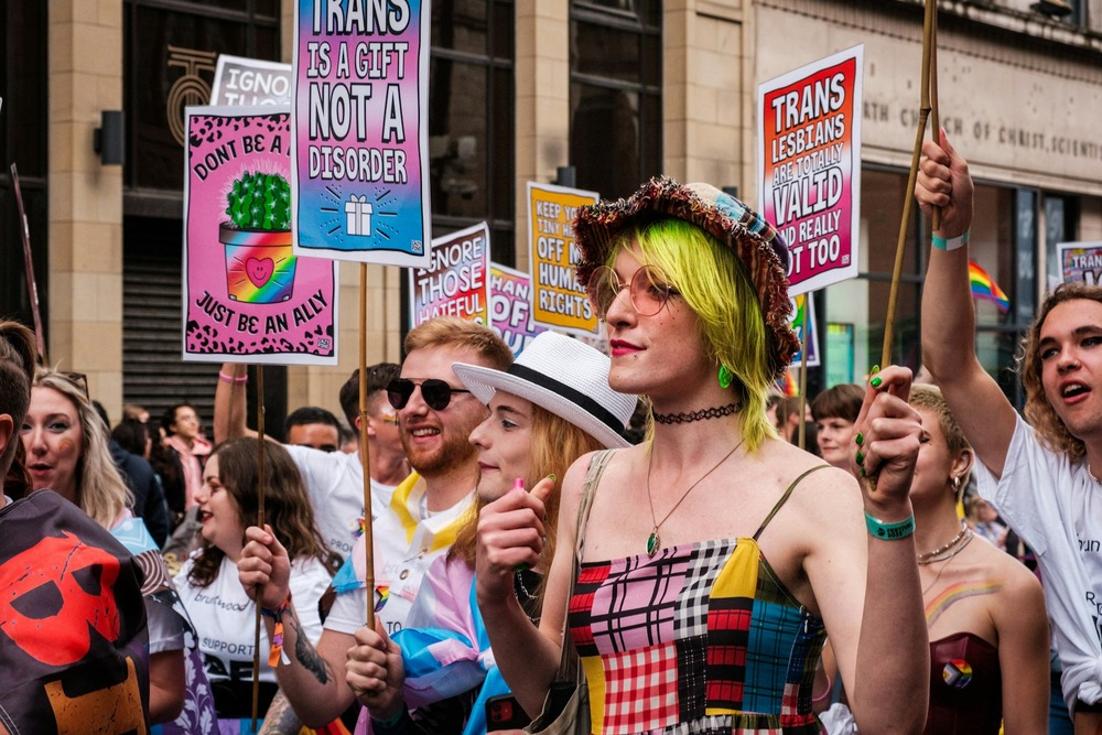 People marching at Manchester Pride with placards