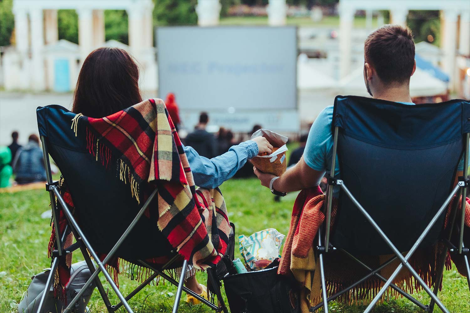 Couple sat in chairs watching an outdoor screening
