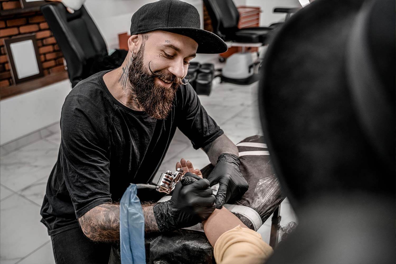Tattoo artist tattooing someone at a tattoo convention